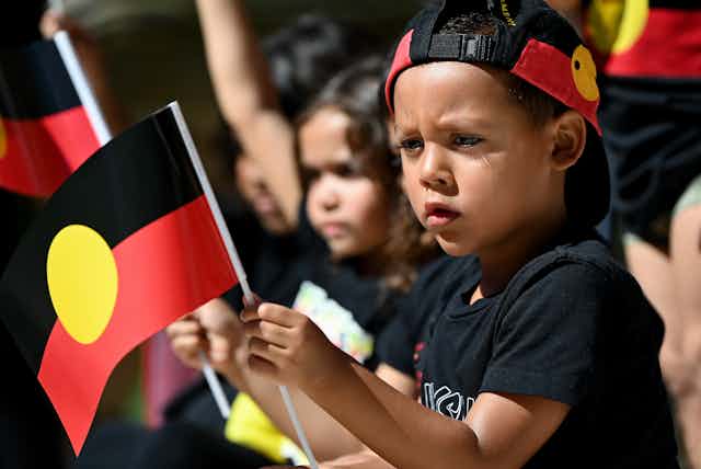 A young boy with an Aboriginal flag