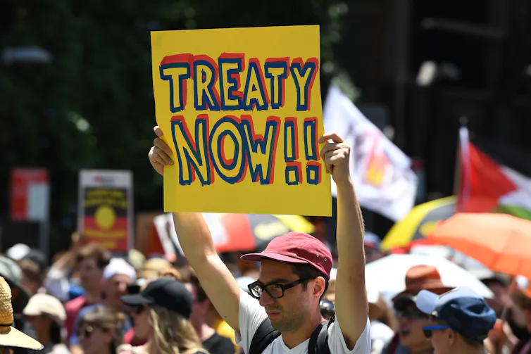 Protest poster reads 'Treaty now'