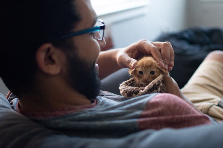 Man holding a kitten