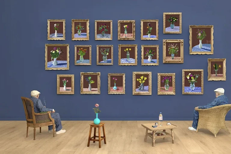 Man sitting admiring flower paintings on a wall.