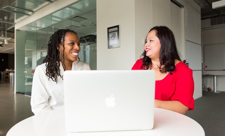 Two women looking at a computer screen