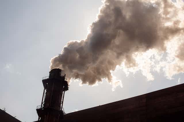 An industrial chimney belching smoke.