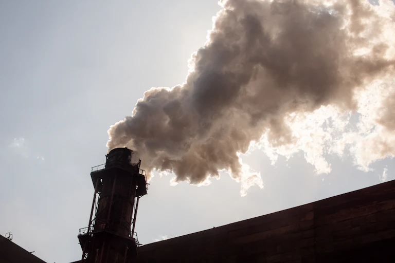 An industrial chimney belching smoke.