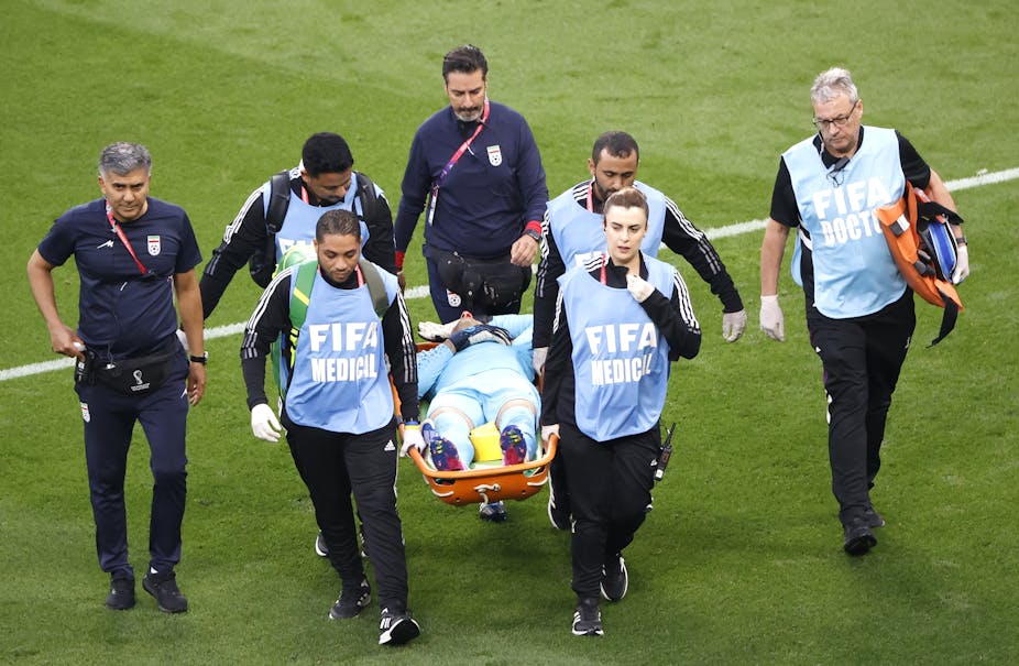  Goalkeeper Ali Beiranvand of Iran is carried on a stretcher.