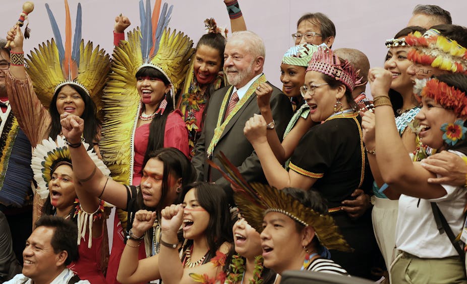 Lula en compagnie de militants indigènes brésiliens en costume traditionnel