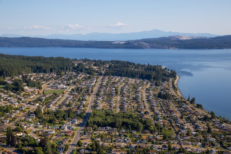 An aerial view of a town by a seashore.