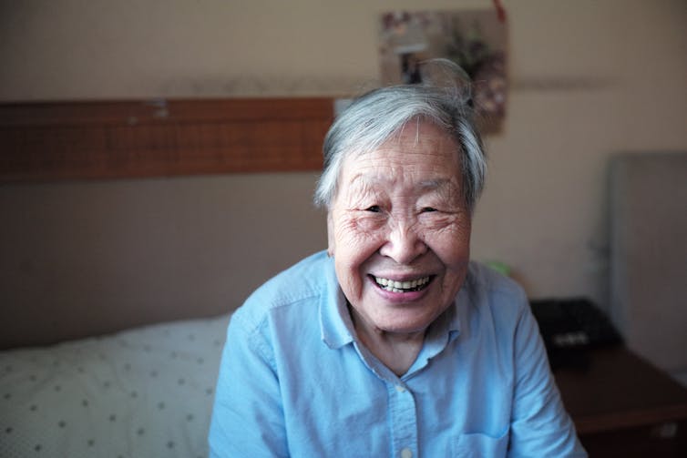 Older person sitting on the bed