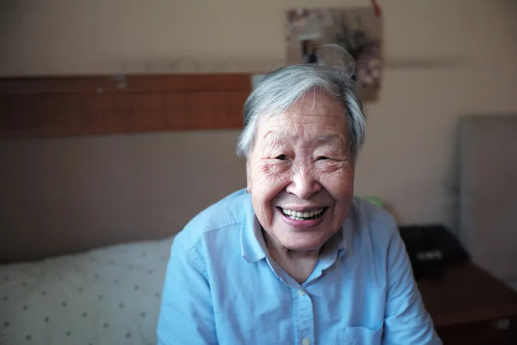 Older person sitting on the bed