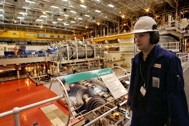 A man in a helmet inside a nuclear plant
