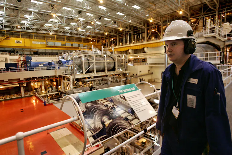 A man in a helmet inside a nuclear plant