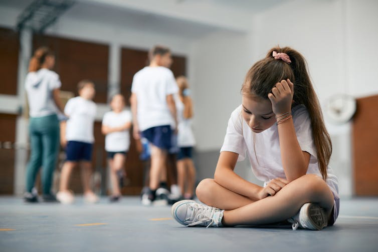 A girl looks sad at a sport match.