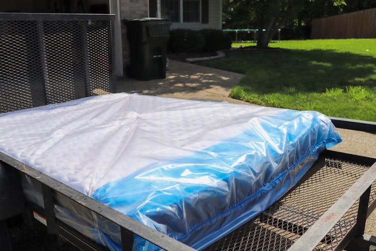 Mattress on the back of a delivery van