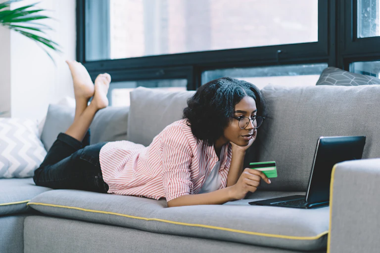 Woman on couch shopping online