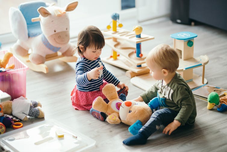 Children playing with teddy