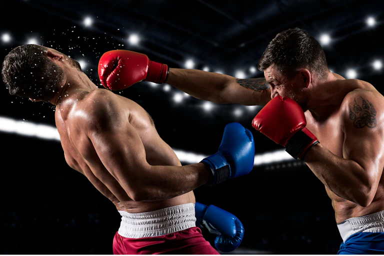 A male boxer punches another male boxer in the face during a fight