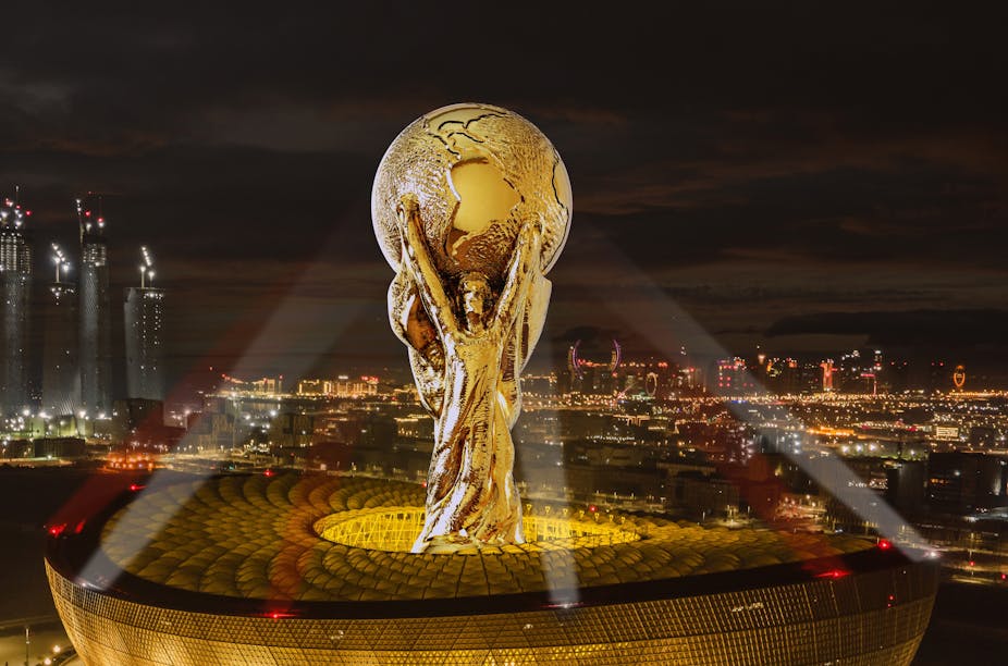 Illustration of World Cup trophy towering over stadium. 