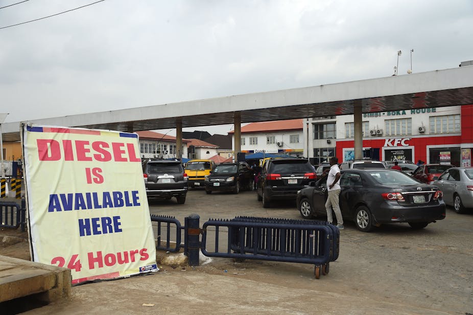 Cars in a queue at a gas station.