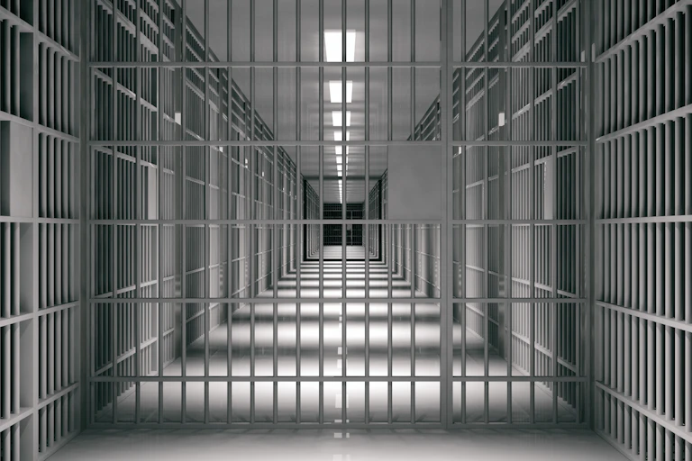 A corridor in a prison lined with jail cells.