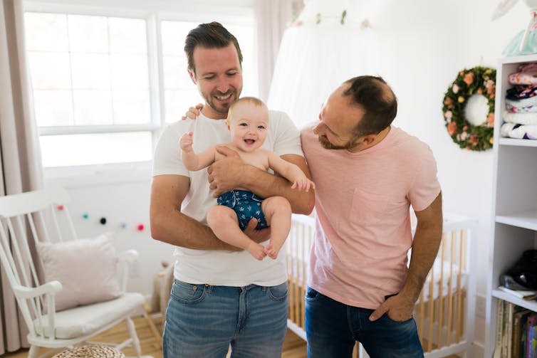 Men holding a baby