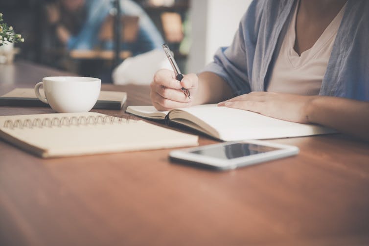 Woman working with smartphone on desk