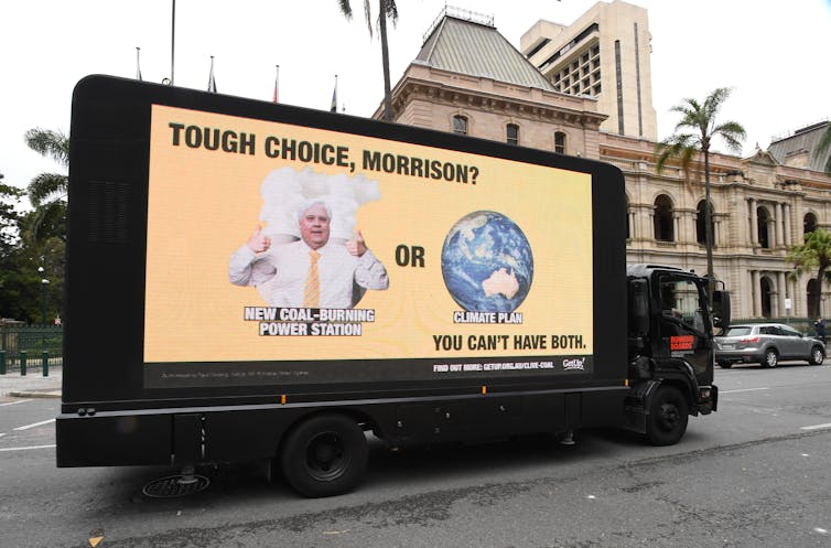 A yellow billboard on a truck
