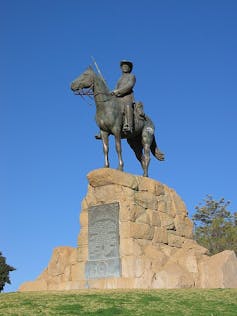 A statue of a man on a horse with a gun.