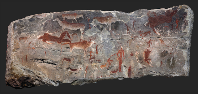 A slab of rock with ochre and white paintings of human and animal figures.