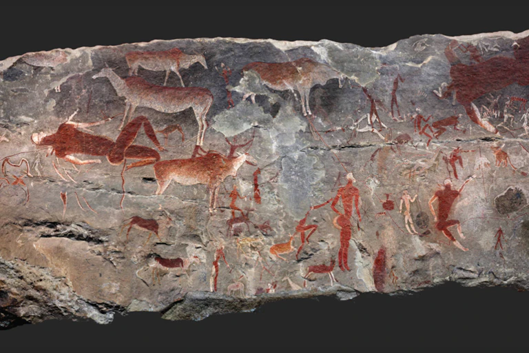 A slab of rock with ochre and white paintings of human and animal figures.