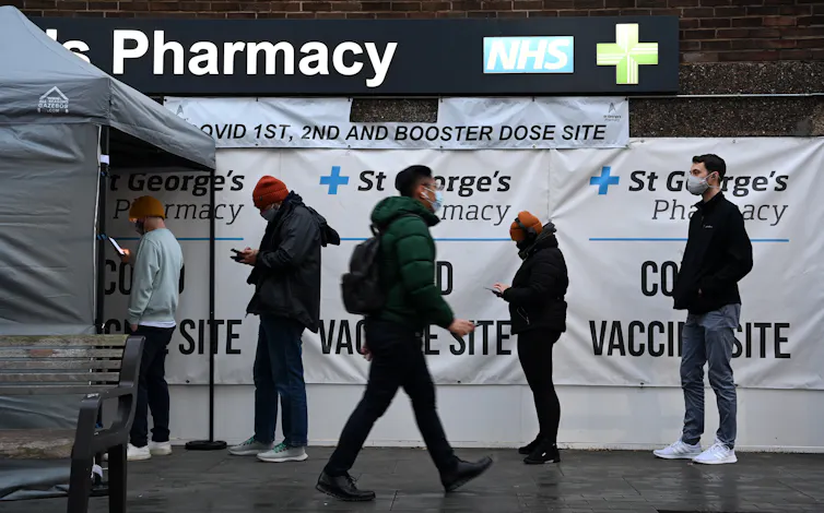 People outside a vaccine site in England in 2021.
