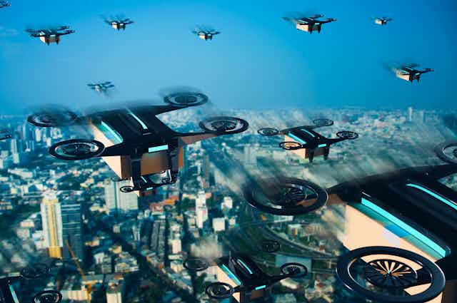 Artist depiction of delivery drones flying through the sky above a large city