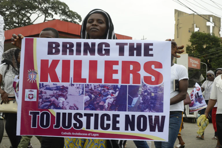 A woman holding a protest banner.