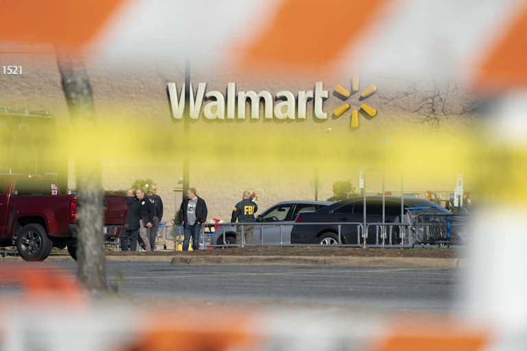 Photograph taken from behind police barriers of FBI agents securing a crime scene at Walmart in Chesapeake Virginia.
