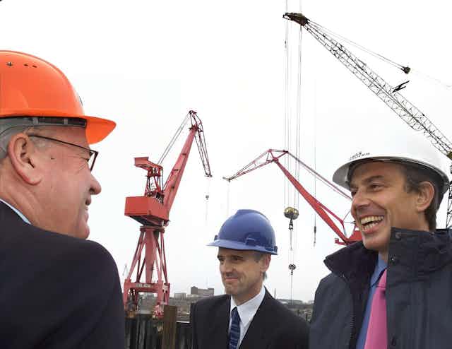 Tony Blair in a hard hat meeting some construction workers