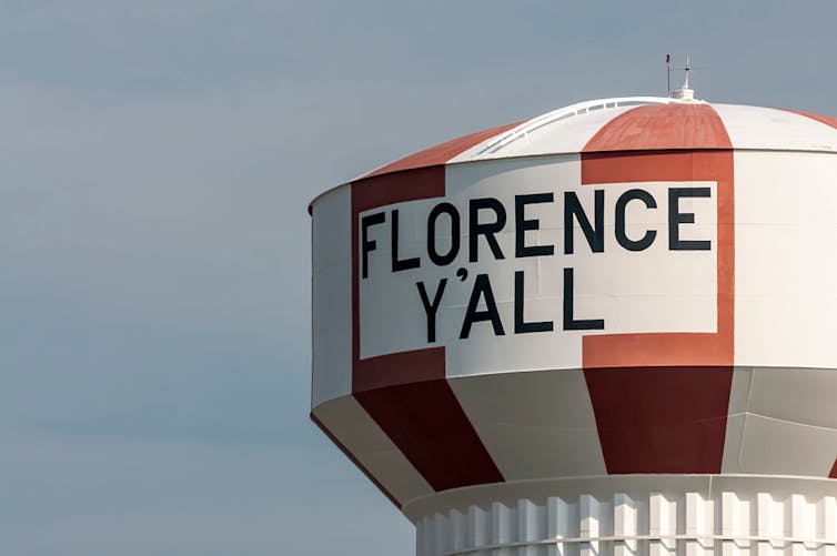 Red and white-striped water tower featuring the text 'Florence Y'all.'