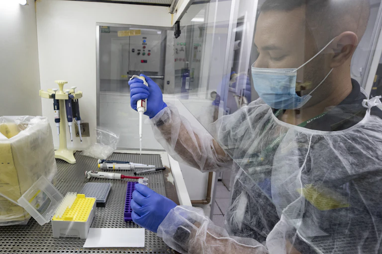A researchers seen in a lab wearing a medical mask.