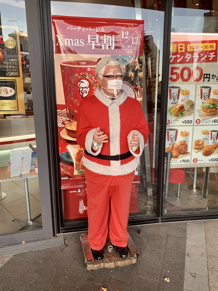 A model of Colonel Sanders, founder of KFC, wearing a red Santa Claus attire, at a KFC in Tokyo, Japan.