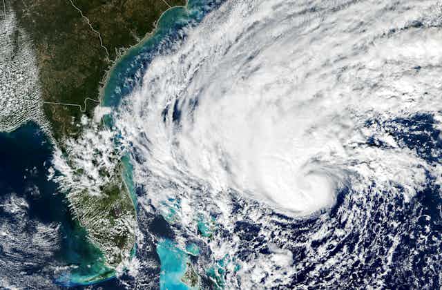Satellite image of a hurricane curling toward Florida from the Atlantic Ocean.