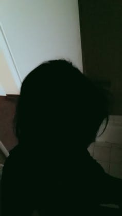 Dark photo of a woman's silhouette