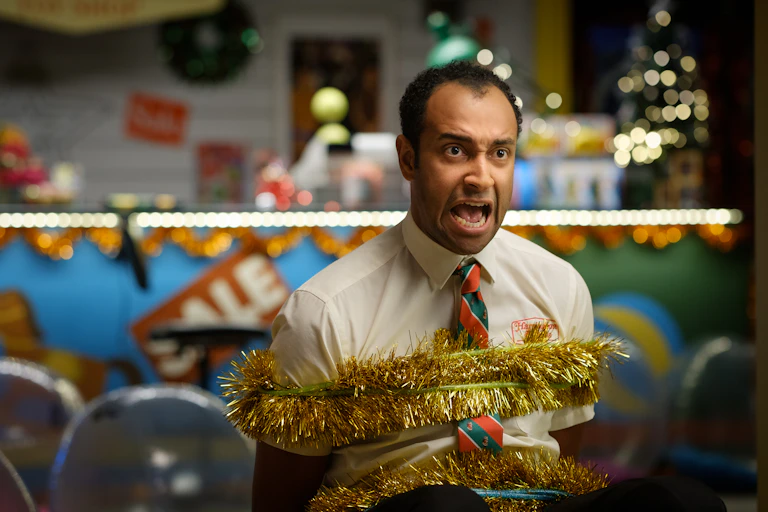 Matt Okine tied up with tinsel.