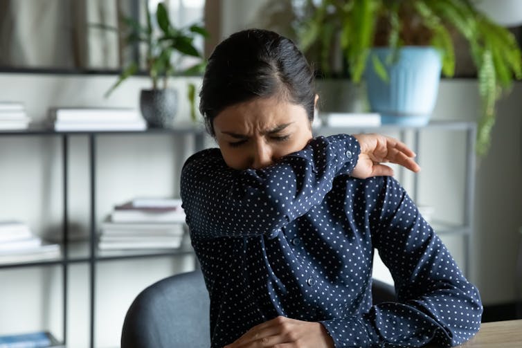 A woman coughing.