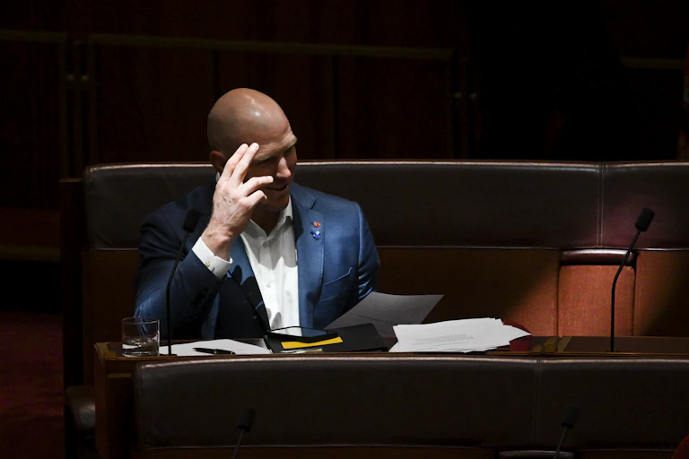 Independent senator David Pocock in the Senate, reading.