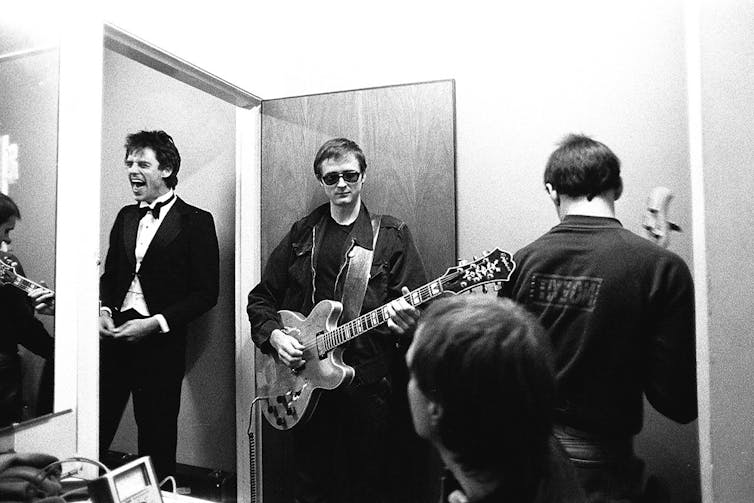 The band in a dressing room.