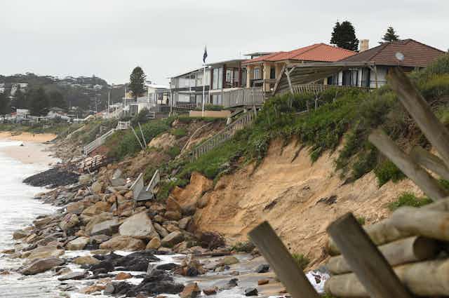 coastal erosion leaves houses at risk of toppling into the sea