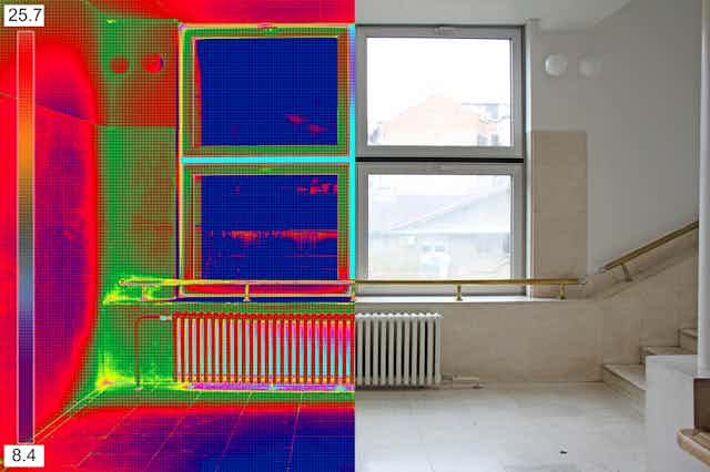 A split image of an apartment hallway with a window and radiator. One side is infrared, the other visual light.