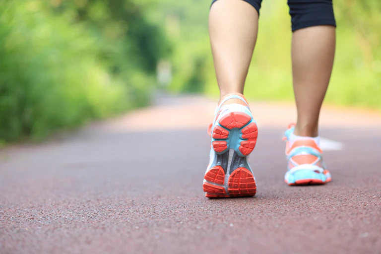 Lower legs of person in running shoes