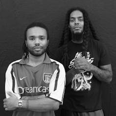 Bob Vylan pose wearing an Arsenal shirt and black rock t-shirt.