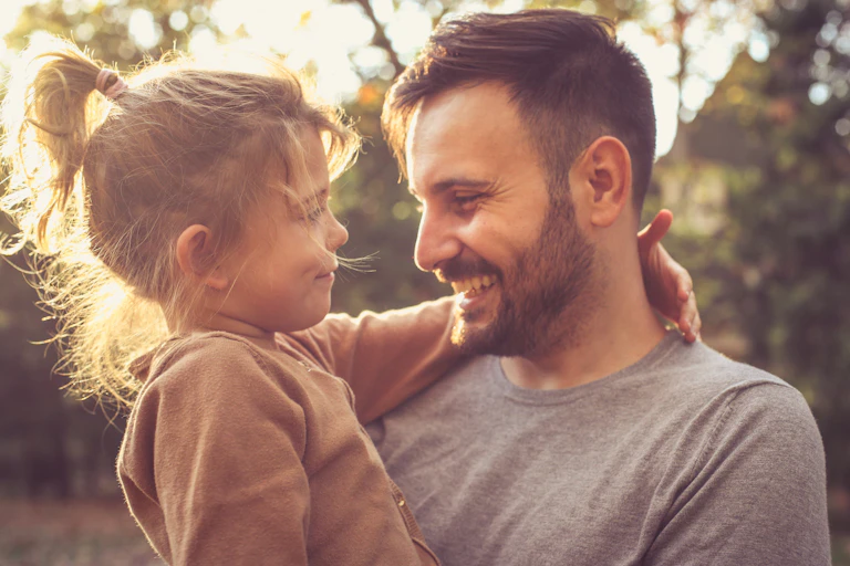 Father holds young daughter