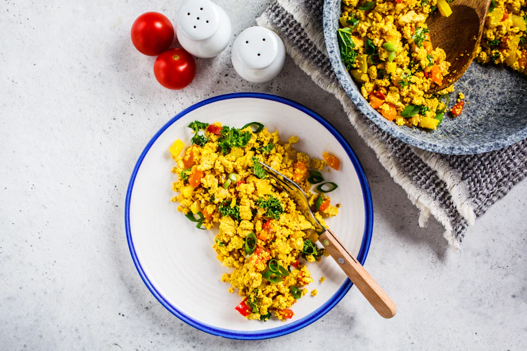 Place and pan of scrambled tofu.