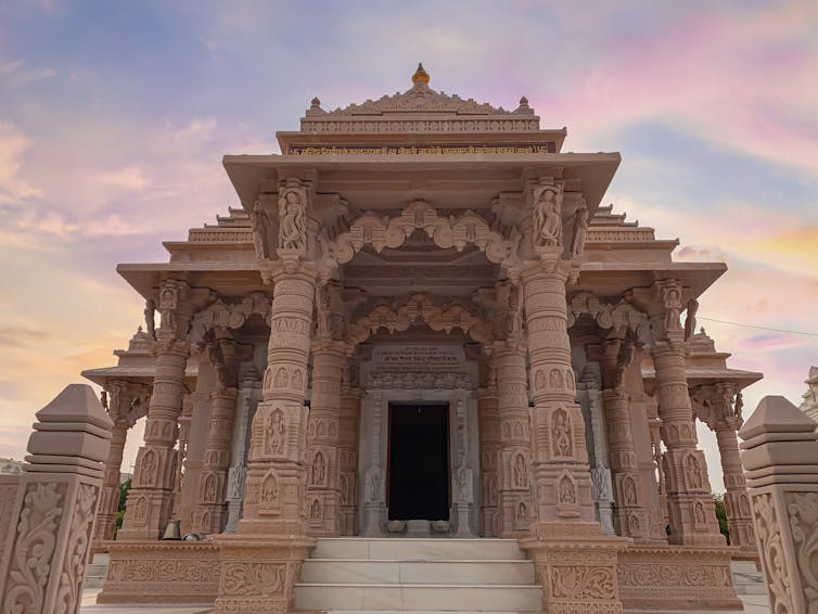An image of the outside of Jain Temple, Jodhpur, India; sunset in the background.