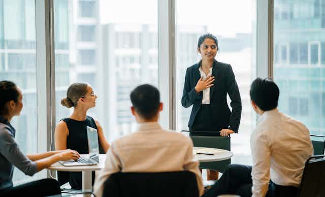 Woman giving presentation in business meeting